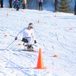 Homer&rsquo;s Jacob Davis maneuvers around orange cones during the first leg of the adaptive sit ski relay race Saturday, Feb. 3, 2018 at the Lookout Mountain Ski Trails. Teams from Homer, Kenai and Soldotna raced teams of four (two standing skiers and two sit skiers) in the relay after the individual 5-kilometer skate races. (Photo by Megan Pacer/Homer News)