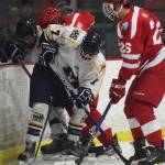 Homer&rsquo;s Tyler Gilliland (7) and Wasilla&rsquo;s Lucas Gudz (right) take part in a battle for the puck along the boards Friday in a North Star Conference tournament semifinal at the Soldotna Regional Sports Complex. (Photo by Joey Klecka/Peninsula Clarion)