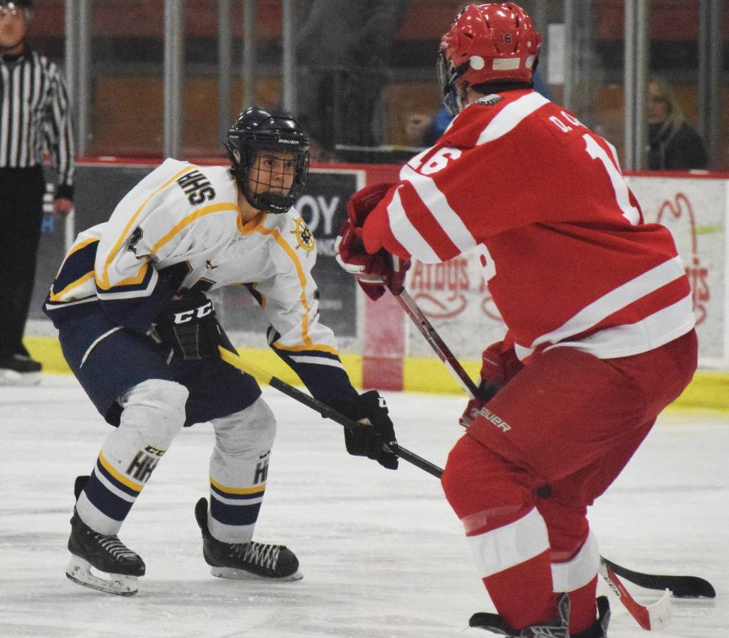 Homer&rsquo;s Isaiah Nevak attempts a move around Wasilla&rsquo;s Devin Carney Friday in a North Star Conference tournament semifinal at the Soldotna Regional Sports Complex. (Photo by Joey Klecka/Peninsula Clarion)