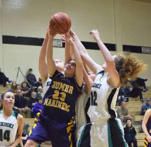 Homer&rsquo;s Maggie Box (23) battles for a rebound with Nikiski&rsquo;s Kaycee Bostic (right) Saturday, Feb. 3, 2018 at Nikiski High School. (Photo by Joey Klecka/Peninsula Clarion)
