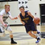 Homer guard Koby Etzwiler (right) makes a move by Nikiski&rsquo;s Jace Kornstad Saturday, Feb. 3, 2018 at Nikiski High School. (Photo by Joey Klecka/Peninsula Clarion)