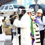 A trumpet player in full costume marches along with the rest of the Bossy Pants March Band in this year&rsquo;s Winter Carnival parade Saturday, Feb. 10, 2018 down Pioneer Avenue in Homer, Alaska. (Photo by Megan Pacer/Homer News)