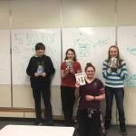 From left to right, Homer Middle School students Tyson Walker, Thea Person, Krystal Super and Lizzy Boyle pose with four of the books they read in preparation for this year&rsquo;s Battle of the Books competition. The team took first place in their age group and will head to the state competition on Feb. 27. (Photo courtesy Joni Wise)