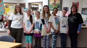 From left to right: Coach Marj Dunn, Bryce Glidden, Syde Schafli, Hadley Glidden, Juliann Techie, Bea McDonough and Coach Holly Alston sport their t-shirts for this year&rsquo;s district-wide Battle of the Books competition. The team, from West Homer Elementary School, took first place in the 5th-6th grade age division and will advance to the state competition on Wednesday, Feb. 28. (Photo submitted)