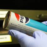 Pratt Museum Collections Manager Savanna Bradley holds a Japanese Pepsi can during a tour of the museum&rsquo;s collections storage Thursday, Feb. 15, 2018 in Homer, Alaska. The museum has a few similarly strange artifacts, which Bradley said are found washed up on shore. (Photo by Megan Pacer/Homer News)