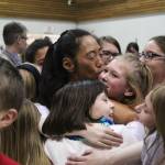 A crowd of students hug dance teacher Jocelyn Shiro after their recital Friday, Feb. 23, 2018 at West Homer Elementary School in Homer, Alaska. (Photo by Megan Pacer/Homer News)
