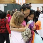 Two students hug dance teacher Jocelyn Shiro after their recital Friday, Feb. 23, 2018 at West Homer Elementary School in Homer, Alaska. (Photo by Megan Pacer/Homer News)
