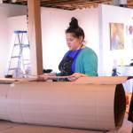 TOP: Artist in Residence Jaimie Warren, center, discusses how to make a log costume with Mila Stickrod, left, and Alex Franklin, right, at her temporary studio at Bunnell Street Arts Center. The Brooklyn, New York, artist visits Homer this month. (Photo by Michael Armstrong, Homer News)