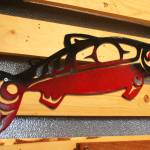 A spraypainted metal fish hangs along with several other creations during a First Friday art show Friday, March 2, 2018 at Grace Ridge Brewery in Homer, Alaska. All the art on display during the show was created by students in Homer High School&rsquo;s Computer Aided Drafting and Computer Aided Manufacturing program. (Photo by Megan Pacer/Homer News)