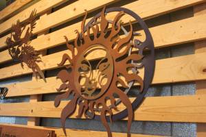A metal sculpture depicting a sun and moon hands along with several other creations during a First Friday art show Friday, March 2, 2018 at Grace Ridge Brewery in Homer, Alaska. All the art on display during the show was created by students in Homer High School&rsquo;s Computer Aided Drafting and Computer Aided Manufacturing program. (Photo by Megan Pacer/Homer News)