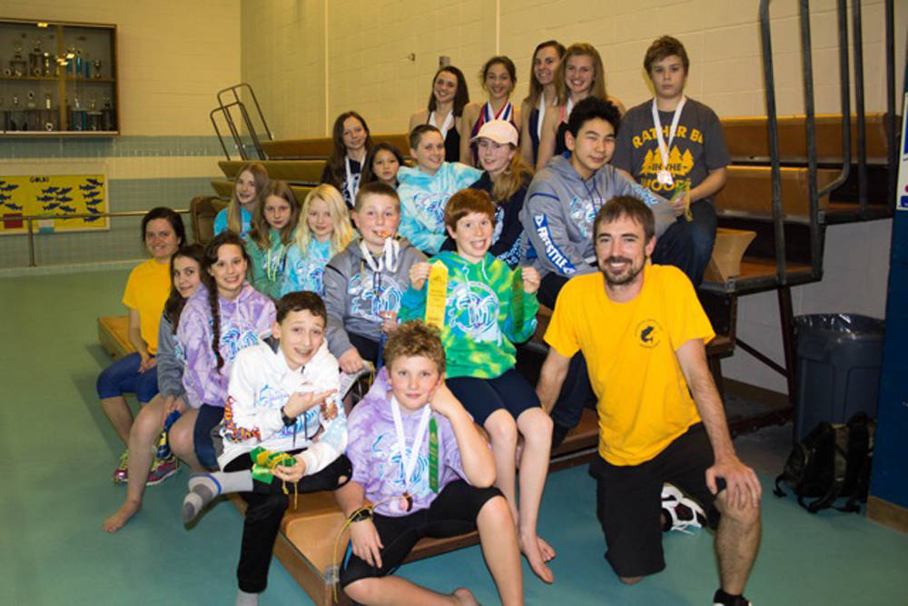 Kachemak Swim Club swimmers who competed at Age Groups in Juneau pose with their medals and ribbons on Feb. 22, 2018 at the Kate Kuhns Aquatic Center in Homer, Alaska. (Photo by Christine Kulcheski)