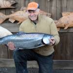 Ron Johnson holds his winning king salmon of 25.65 pounds, at the 24th annual Homer Winter King Tournament on Saturday, March 23, 2017. One-thousand and 12 anglers registered in the tournament in 314 boats, catching 110 king salmon weighing 1,584 pounds total. Anglers also caught 27 white kings weighing 438 pounds total. (Photo by Michael Armstrong, Homer News).