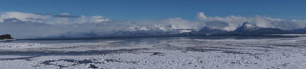 Snowfall over the weekend covered ice floes on Mud Bay in this panoramic view of the Kenai Mountains and the Spit on Saturday, March 10, 2018 in Homer, Alaska. (Photo by Michael Armstrong, Homer News)