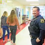 Kenai Police Officer Dan Smith, school resource officer and investigator, walks the hallways at Kenai Central High School on March 5. Smith acts as a liaison between law enforcement and the schools. (Photo by Erin Thompson/Peninsula Clarion)