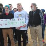 From left to right: Freshman Jack Strydom, freshman River Mann and science teacher Bruce Rife stand with a group of about 100 students and some staff who staged a walkout at Homer High School on Wednesday, Feb. 21, 2018 in Homer, Alaska. Their sign reads, &ldquo;It&rsquo;s a toe tag, not a price tag.&rdquo; (Photo by Megan Pacer/Homer News)