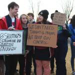 Senior Elan Carroll and senior Drew Wimmerstedt stand with about 100 of their classmates, and some staff, during a walkout Wednesday, Feb. 21, 2018 at Homer High School in Homer, Alaska. The signs, made by Wimmerstedt, read &ldquo;208 shootings since Columbine and counting. #Enough,&rdquo; and &ldquo;We don&rsquo;t need thoughts and prayers, we need gun control.&rdquo; (Photo by Megan Pacer/Homer News)