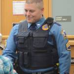 Sgt. Daniel Cox congratulates a Kenai Peninsula Youth Court attorney at swearing-in ceremonies at the Homer Courthouse in December 2016. (Photo by Michael Armstrong, Homer News)