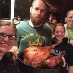 Blood, Sweat, and Food co-owner Beau Burgess, center, holds a turkey fresh from the oven. Next to him are co-owners Aryn Young, left, Jenni Medley, second from right, and Tony Burgess, far right. (Photo by Jennifer Tarnacki)