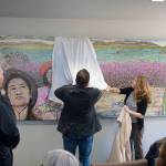 Homer artist Marjorie Scholl, far right, unveils her new painting, &ldquo;Sharing Spaces Orange Roe,&rdquo; at an open house for the expanded and remodeled clinic last Friday, March 30, 2018 on Bartlett Street in Homer, Alaska. The South Peninsula Hospital Foundation commissioned and donated the painting to the clinic. (Photo by Michael Armstrong, Homer News)