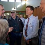 South Peninsula Service Area Board members William Runnoe, left, Roberta Highland, center, back to camera, and Ralph Broshes, right, visit with new SPH CEO Joseph Woodin, second from right. Also listening is Robert Archibald, second from left. Woodin started work last month and attended an open house for the expanded and remodeled clinic last Friday, March 30, 2018 on Bartlett Street in Homer, Alaska. (Photo by Michael Armstrong, Homer News)