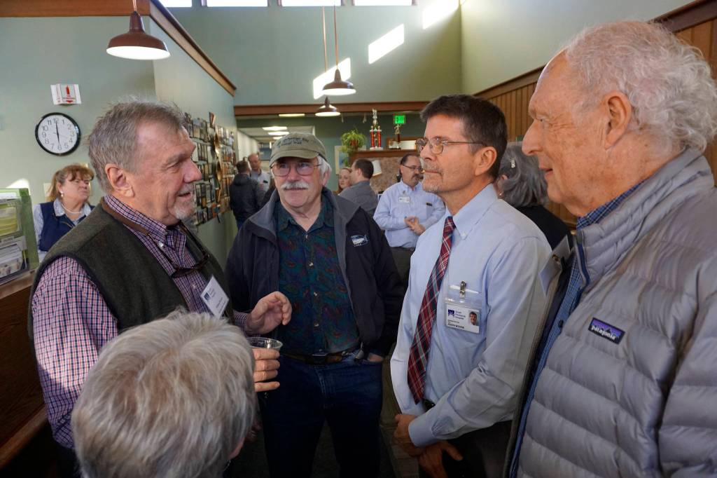 South Peninsula Service Area Board members William Runnoe, left, Roberta Highland, center, back to camera, and Ralph Broshes, right, visit with new SPH CEO Joseph Woodin, second from right. Also listening is Robert Archibald, second from left. Woodin started work last month and attended an open house for the expanded and remodeled clinic last Friday, March 30, 2018 on Bartlett Street in Homer, Alaska. (Photo by Michael Armstrong, Homer News)