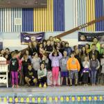 Photo by Monica Anderson Members of the Kachemak Swim Club pose with their first place trophy after an invitational meet they hosted Friday and Saturday, April 6-7 at the Kate Kuhns Aquatic Center in Homer.