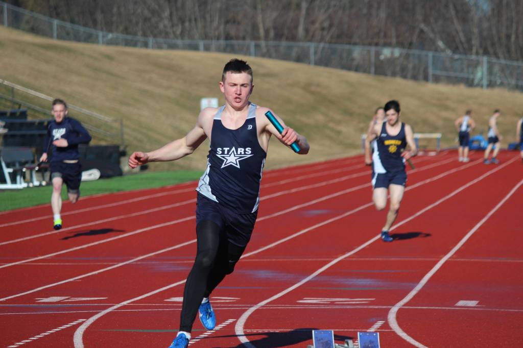 Soldotna High School&rsquo;s Brenner Furlong crosses the finish line to claim first place for the boys&rsquo; 1,600-meter relay Friday, April 13, 2018, at Homer High School in Homer Alaska. The two schools faced off in a dual meet. (Photo by Megan Pacer/Homer News)
