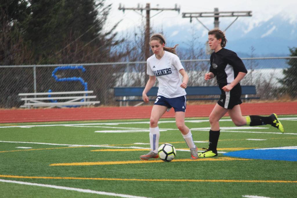 Homer&rsquo;s Laura Inama keeps the ball away from a Nikiski player during the varsity girls game at home Tuesday, April 17, 2018 in Homer, Alaska. The Mariners swept the Bulldogs 3-0. (Photo by Megan Pacer/Homer News)