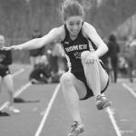 Homer freshman Laura Inama leaps into the sand pit in the girls long jump Saturday afternoon at Homer High School. (Photo by Joey Klecka/Peninsula Clarion)