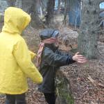 Charles Robinette, left, leads classmate Fox Strobel through the woods behind Little Fireweed Academy while Strobel is blindfolded during a game called &ldquo;Sneaky Sneaky Squirrel&rdquo; on Tuesday, April 24, 2018 at the school in Homer, Alaska. The Fireweed students are participating in several outdoor games and lessons through a mentorship program with Homer High School students. (Photo by Megan Pacer/Homer News)