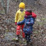 Riggs Harness coaches classmate Violet Pinsky through the woods while blindfolded during a game designed to teach them how animals communicate with each other on Tuesday, April 24, 2018 at Little Fireweed Academy on Homer, Alaska. Students played the games under the supervision of the Homer High School mentors who created them. (Photo by Megan Pacer/Homer News)