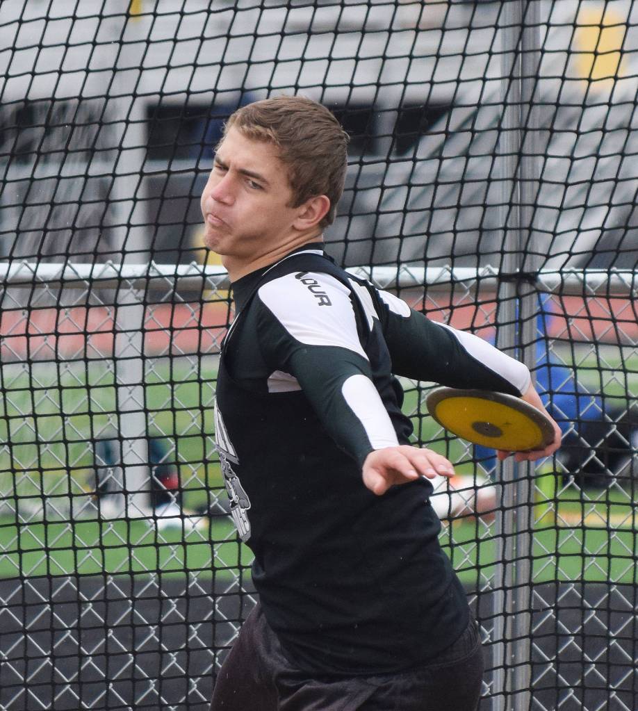 Nikiski senior Ian Johnson spins the discus en route to winning the boys event Saturday at the Kenai Invitational at Ed Hollier Field. (Photo by Joey Klecka/Peninsula Clarion)