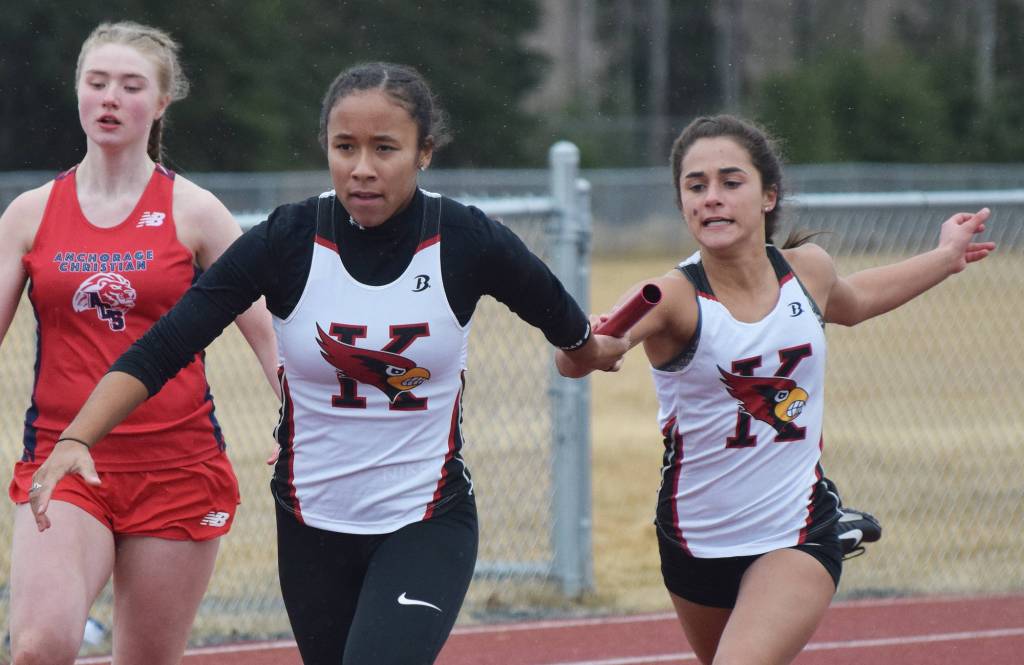 Kenai sophomore Alyssa Bucho (right) hands the baton off to senior teammate Tekaiya Rich in the girls 400-meter sprint relay Saturday at the Kenai Invitational at Ed Hollier Field. (Photo by Joey Klecka/Peninsula Clarion)