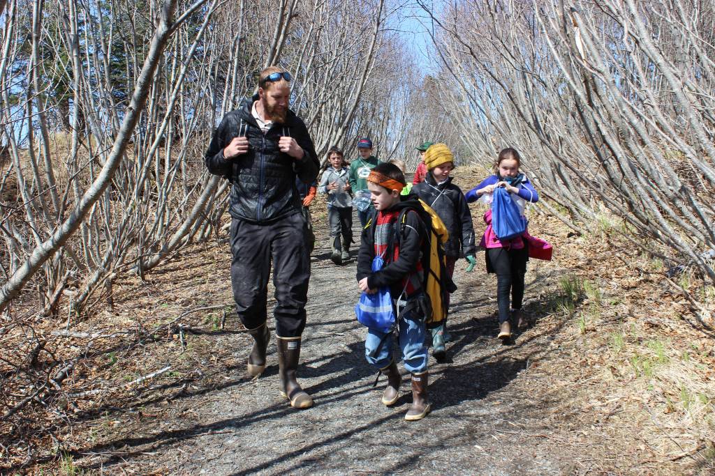 Elementary school students in the Kenai Peninsula Borough School District&rsquo;s after-school Wilderness Explorers program head down Diamond Creek Trail on Wednesday, May 2, for an afternoon of identifying, collecting and eating edible wild plants. Adult volunteer Derek Brynagle walks with students (front, left to right) Alexander Kulikov, Maddy Miotke, Britta Velsko and (back, left to right) Lars Dickson, Mavricky Kulikov and Ellis Lorentz. (Photo by McKibben Jackinsky)