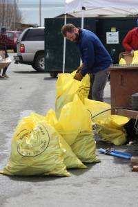 Volunteers help sort bags of trash cleaned from around Homer on Saturday, May 5, 2018 during the city&rsquo;s annual Clean Up Day in Homer, Alaska. The Homer Chamber of Commerce gives out prizes to the those who collect the most bags of trash in different categories. (Photo by Megan Pacer/Homer News)