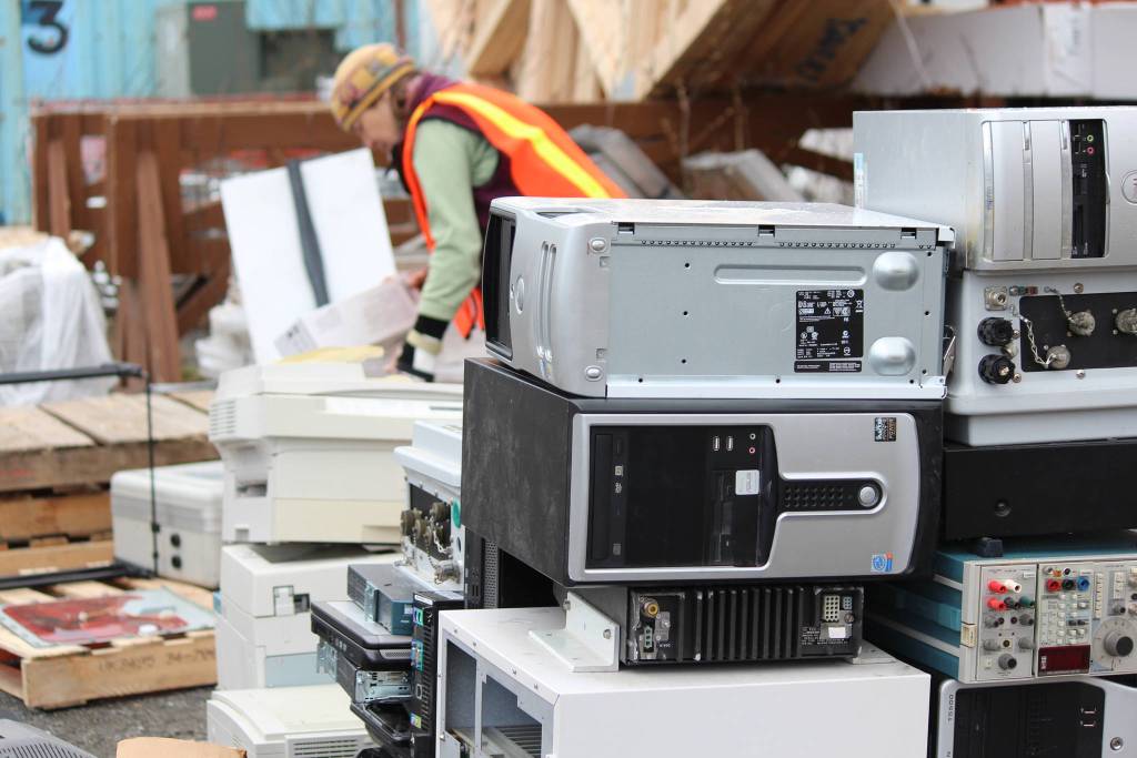 Above: Piles of computers wait to be packaged and loaded onto a truck in the business section of the Cook Inletkeeper&rsquo;s electronics recycling event Saturday, May 5, behind Spenard Builders Supply in Homer. Left: Volunteers help sort bags of trash cleaned from around Homer on Saturday, May 5 during the city&rsquo;s annual Clean Up Day in Homer. The Homer Chamber of Commerce gives out prizes to the those who collect the most bags of trash in different categories. (Photos by Megan Pacer/Homer News)