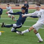 Photo by Joey Klecka/Peninsula Clarion Homer&rsquo;s Charlie Menke (11) attempts to intercept a shot taken by Kenai Central&rsquo;s Zack Tuttle Tuesday evening at Ed Hollier Field in Kenai.