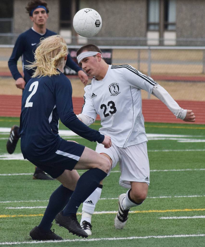 Kenai&rsquo;s Zack Tuttle (23) and Homer&rsquo;s Charles Rohr battle for a header Tuesday evening at Ed Hollier Field in Kenai. (Photo by Joey Klecka/Peninsula Clarion)