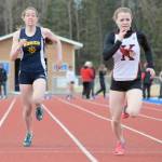 Kenai Central&rsquo;s Hayley Maw pulls away from Homer&rsquo;s Laura Inama to win the 100-meter dash at the Kenai Peninsula Borough track and field meet Saturday, May 12, 2018, at Soldotna High School. (Photo by Jeff Helminiak/Peninsula Clarion)
