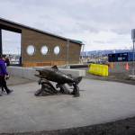 People walk by Wildheart, the Giving Salmon, sculpture Saturday, May 12, 2018 after the ribbon cutting for the Homer Boat House. (Photo by Michael Armstrong/Homer News)