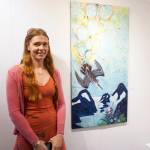 Erin Rae D&rsquo;Eimon stands by one of her paintings at the First Friday opening for her show on May 4, 2018 at the Homer Council on the Arts in Homer, Alaska. (Photo by Michael Armstrong/Homer News)