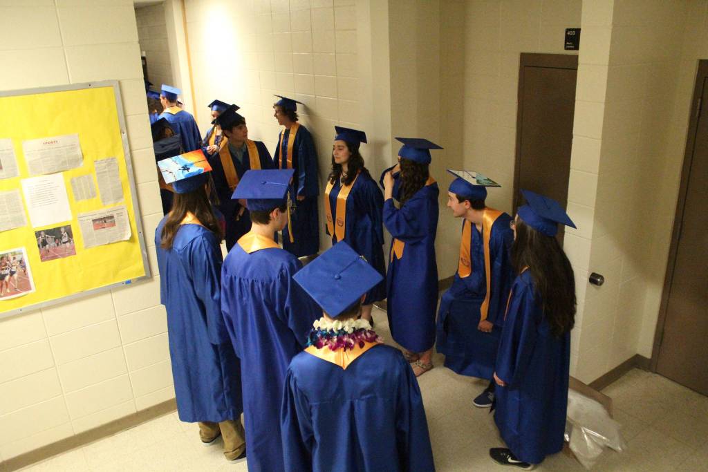 Homer High School graduates await their ceremony outside the Alice Witte Gymnasium on Tuesday, May 22, 2018 at the school in Homer, Alaska. (Photo by Megan Pacer/Homer News)