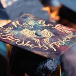 A Homer High School graduate with a cap decorated to say &ldquo;She may be little, but she is fierce,&rdquo; listens during the commencement ceremony for her graduating class Tuesday, May 22, 2018 at the school in Homer, Alaska. (Photo by Megan Pacer/Homer News)