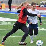 Kenai defender Damaris Severson (left) attempts to keep the ball away from Homer&rsquo;s Raisa Basargin Friday in a Peninsula Conference tournament semifinal at Soldotna High School. (Photo by Joey Klecka/Peninsula Clarion)