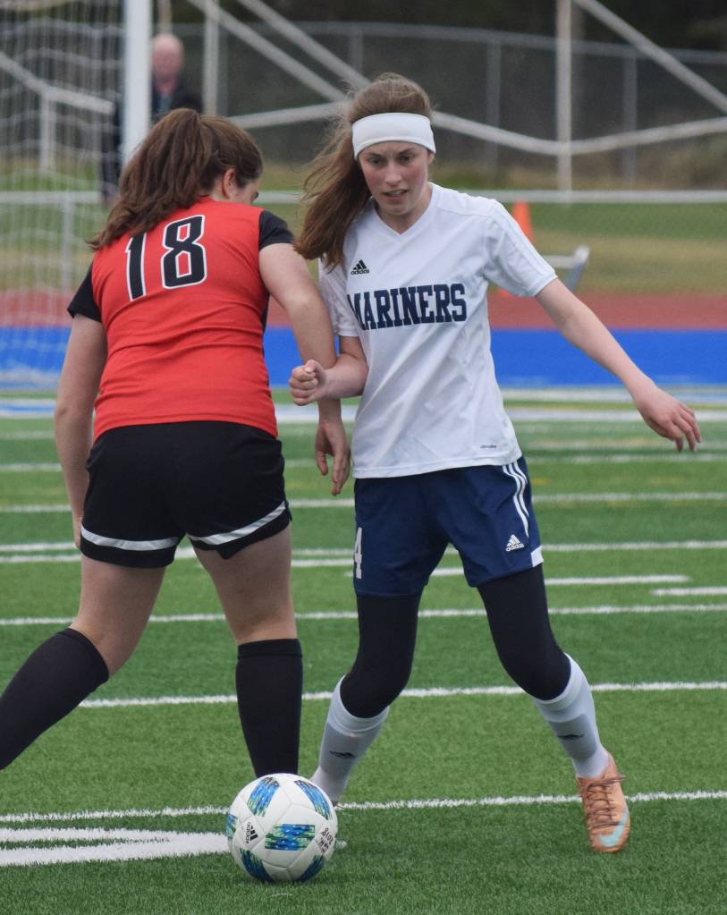 Homer&rsquo;s Andie Sonnen (right) attempts to swipe the ball from Kenai&rsquo;s Rachael PItsch Friday in a Peninsula Conference tournament semifinal at Soldotna High School. (Photo by Joey Klecka/Peninsula Clarion)