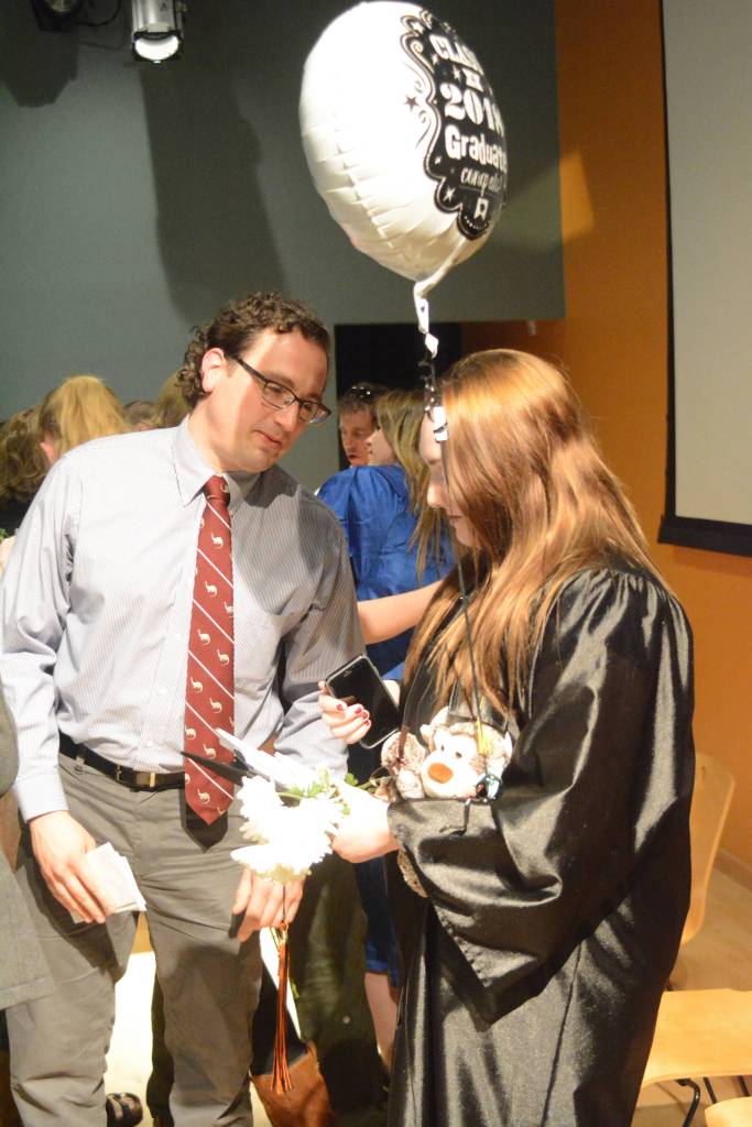 Flex High School teacher David Lefton, left, congratulates Brittany Griffin after she graduated. Nine students graduated from Flex on Tuesday night, May 22, 2018, at the Alaska Islands and Ocean Visitor Center auditorium, Homer, Alaska. (Photo by Michael Armstrong / Homer News)
