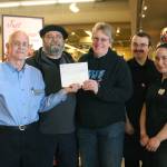 From left to right: Homer Safeway Store Manager Bob Malone, Peter Norton, Laura Norton, Chris Long and Tasha Taylor pose with a check being presented to Laura Norton on Tuesday, May 22, 2018 at the grocery store in Homer, Alaska. Norton won $20,000 through the Safeway Monopoly Game. (Photo by Megan Pacer/Homer News)
