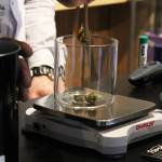 Photo by Megan Pacer/Homer News Aaron Stiassny measures out marijuana buds during the opening day of Uncle Herb&rsquo;s, Homer&rsquo;s first retail marijuana store, on Thursday, May 24 in Homer.