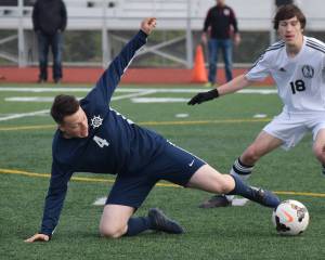 Homer&rsquo;s Timothy Blakely (4) redirects the ball Friday in a Division II state tournament semifinal against Kenai Central at Service High School. (Photo by Joey Klecka/Peninsula Clarion)