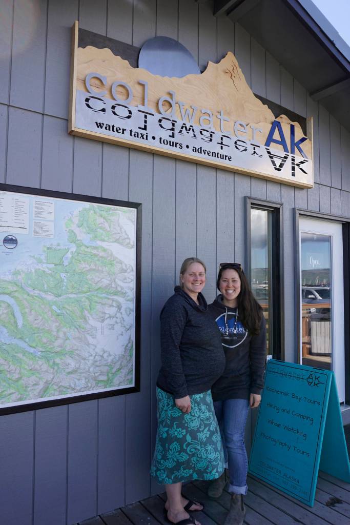 Lisa Conley, left, and Soniyae Reid, right, on Friday, June 1, 2018, stand outside the new offices of Coldwater AK water taxi and tour company in the Centra Charters Boardwalk on the Homer Spit.